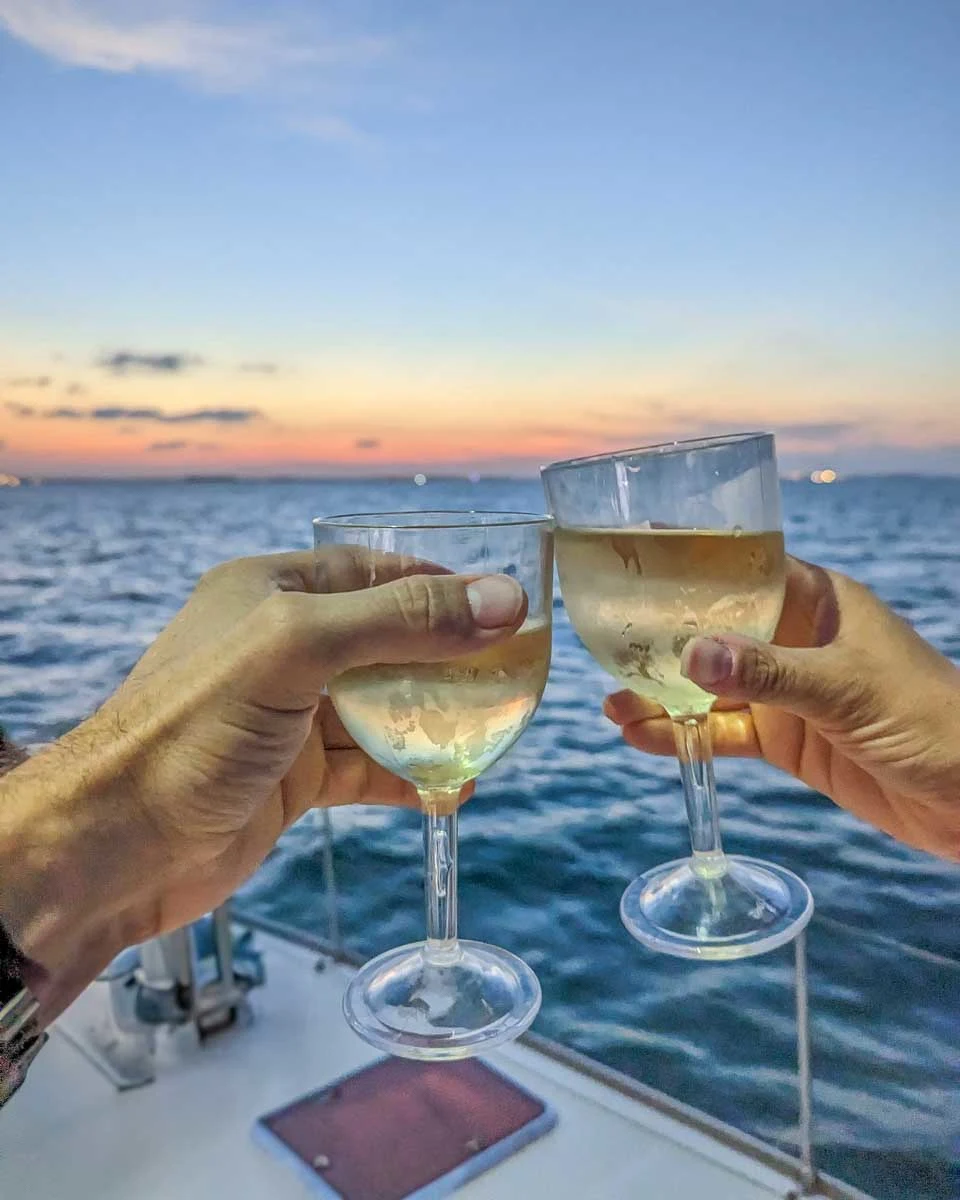 Bailey-and-Daniel-cheers-with-wine-at-sunset-on-a-cruise-in-Fiji