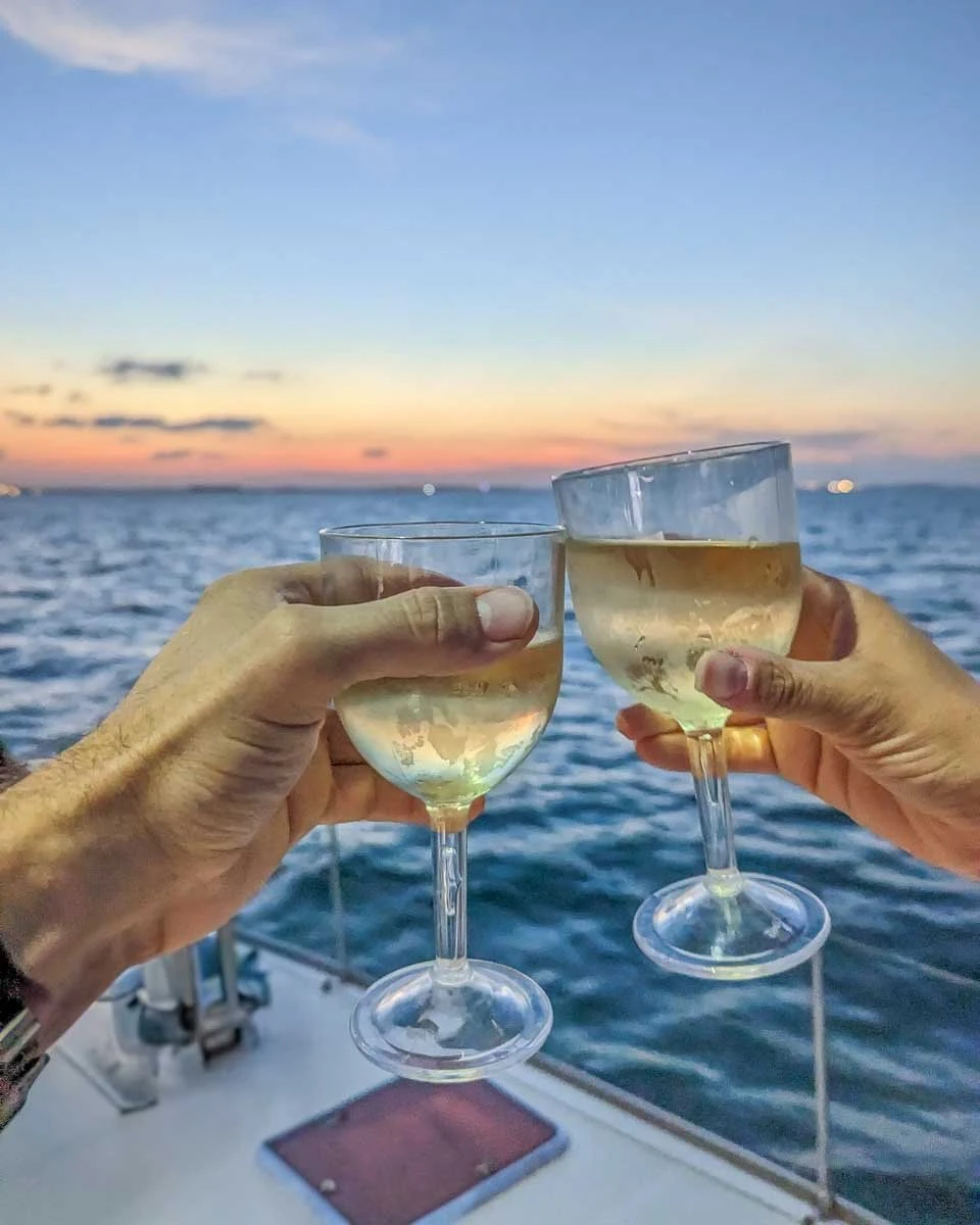Bailey-and-Daniel-cheers-with-wine-at-sunset-on-a-cruise-in-Miami Florida