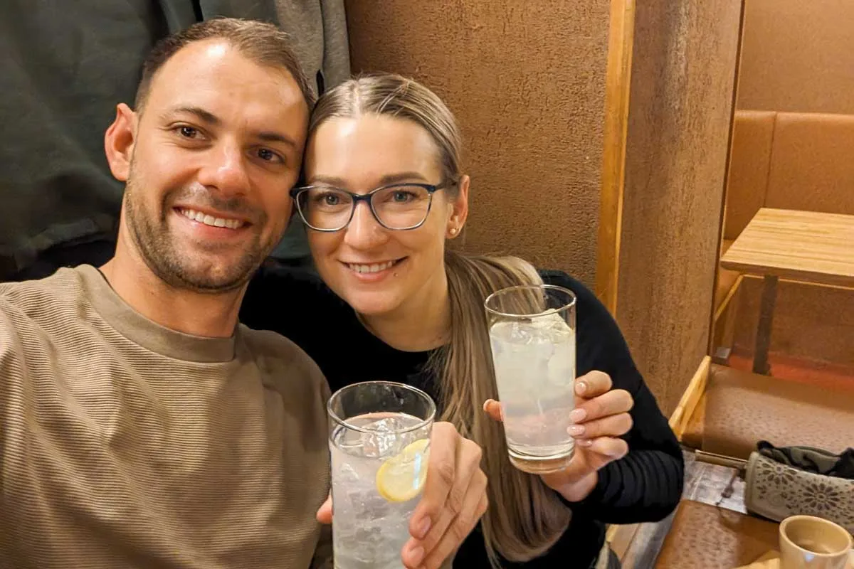 Bailey-and-Daniel-take-a-selfie-while-holding-drinks-on-a-night-tour-in-Seoul South Korea