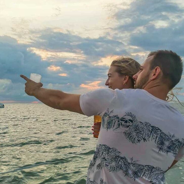 Daniel-points-to-something-while-on-a-sunset-cruise-from Kauai Hawaii
