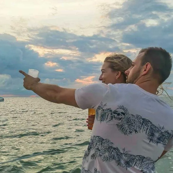 Daniel-points-to-something-while-on-a-sunset-cruise-from Kauai Hawaii