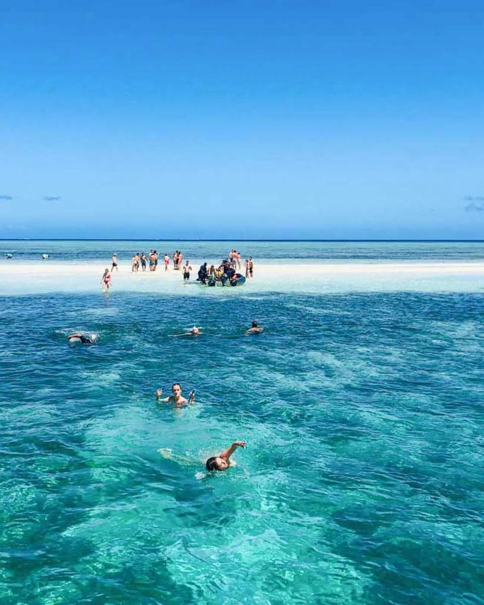People-swim-around-a-sandbar-on-the-Cruisin-Fiji-Authentic-Fijian-Day-Cruise