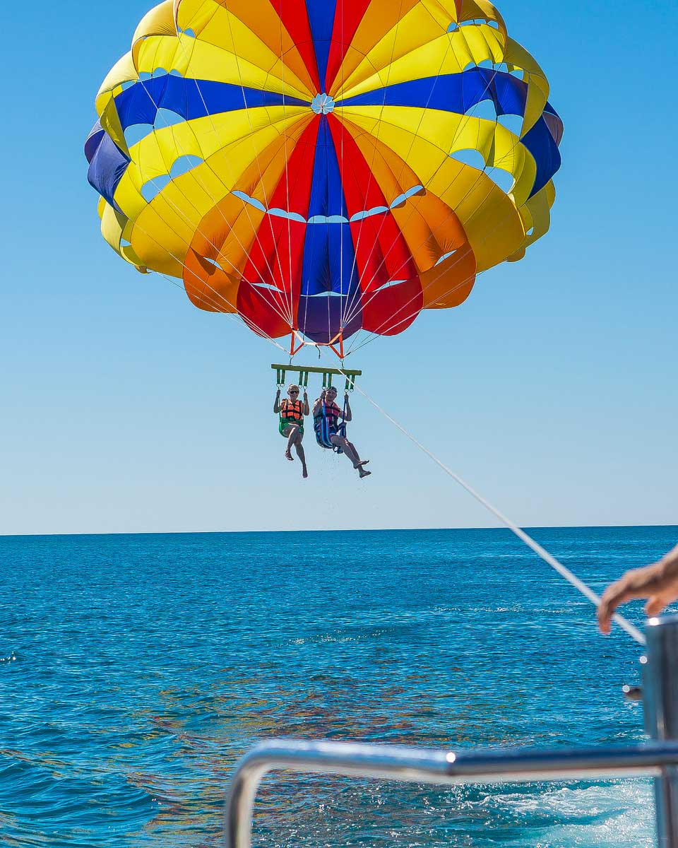 Two-people-parasail-over-the-ocean-near Catalina Island California