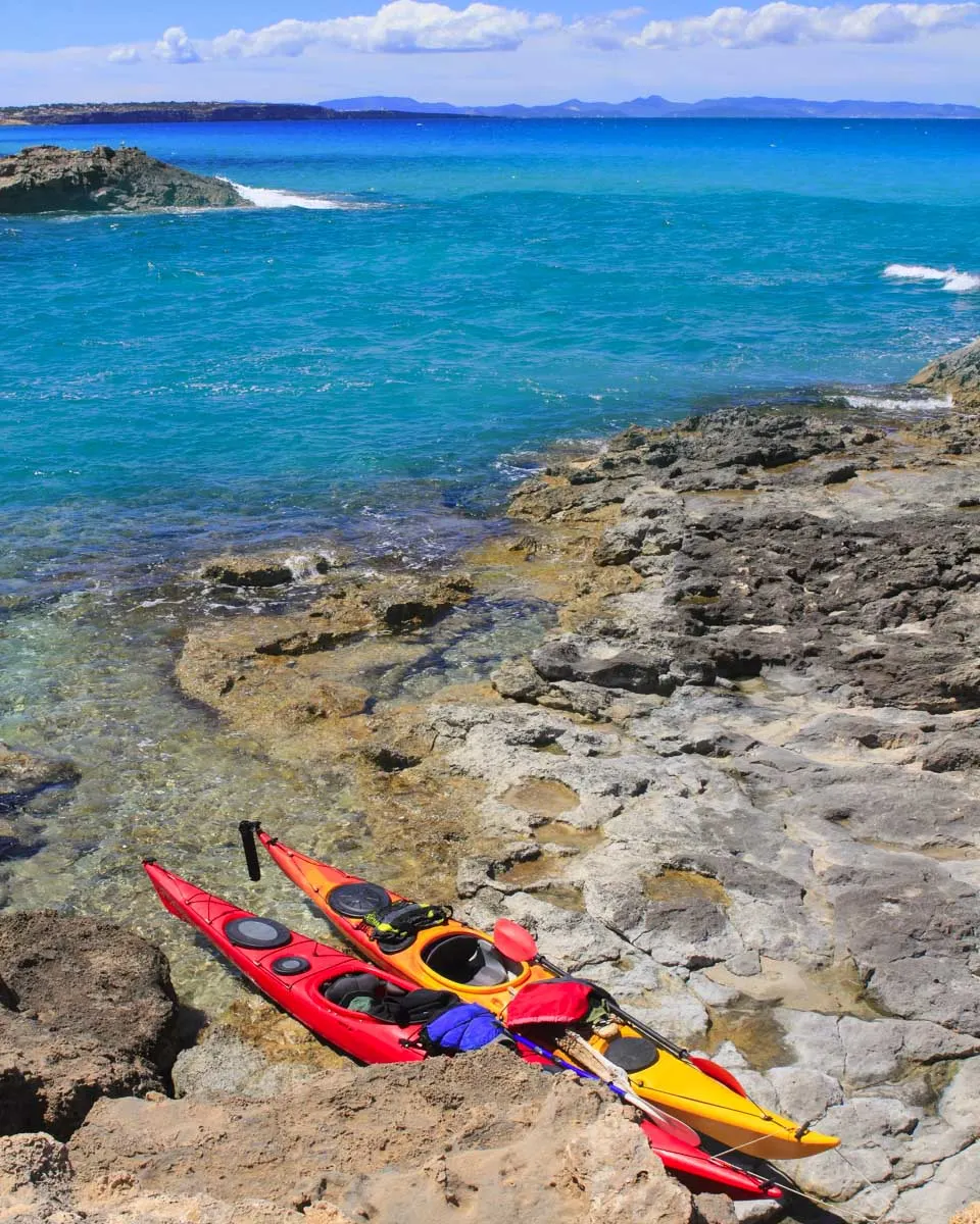 Kayaks by the water on a tour from Ibiza Spain