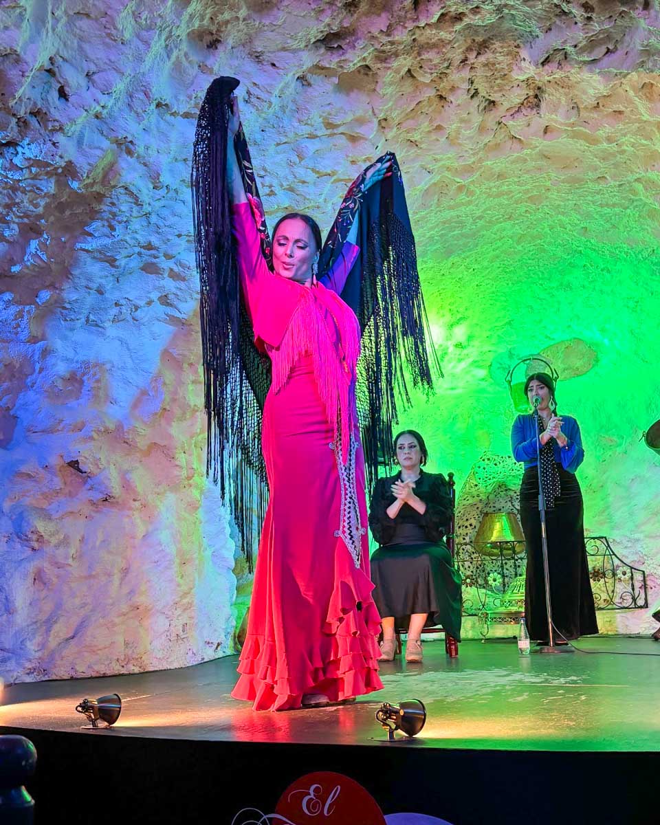 A woman dances flamenco at a cave theatre in Granada, Spain