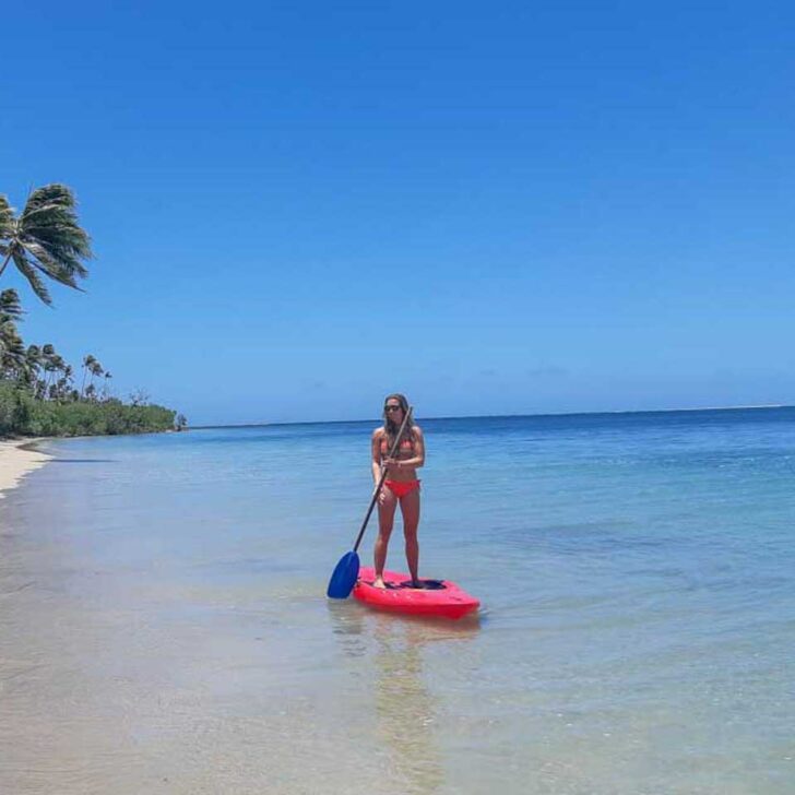 Bailey-on-a-stand-up-paddle-board-out-in-the-water-of-Palm Beach Aruba