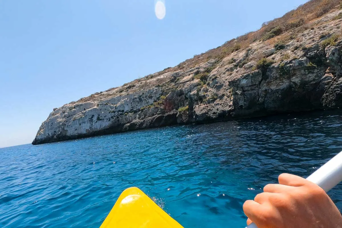 Daniel kayaks off of the coast of Sardinia Italy on a tour
