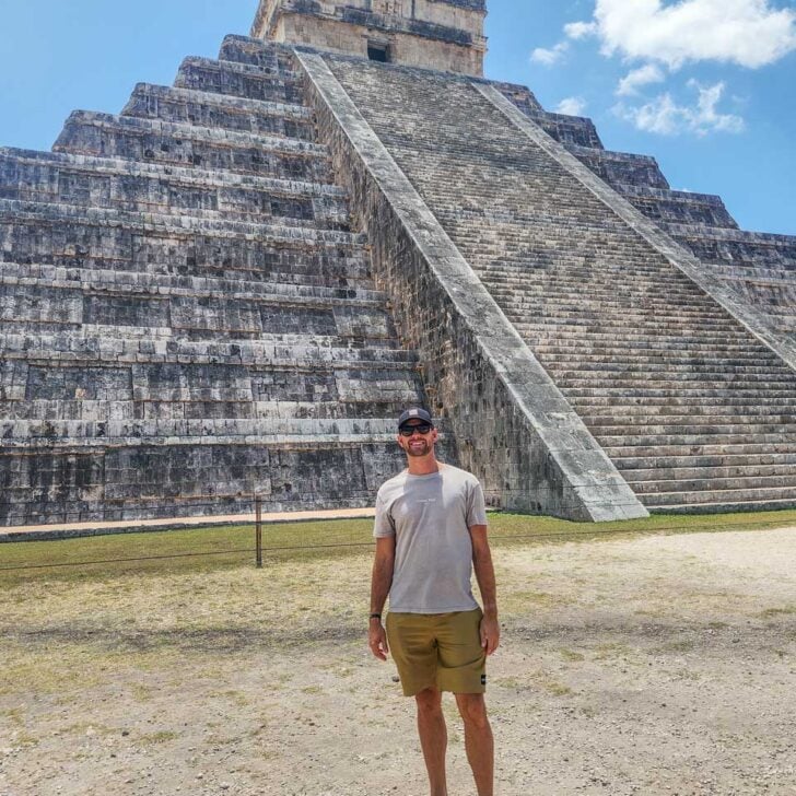 Daniel-poses-for-a-photo-with-the-main-pyramid-at-El-Castillo-Chichen-Itza on a tour from Playa del Carmen Mexico