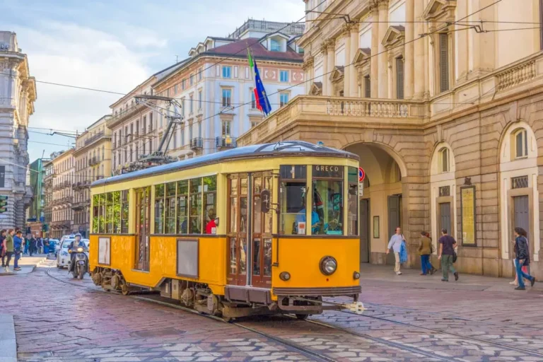 Old tram passing at La Scala theatre in Milan Italy
