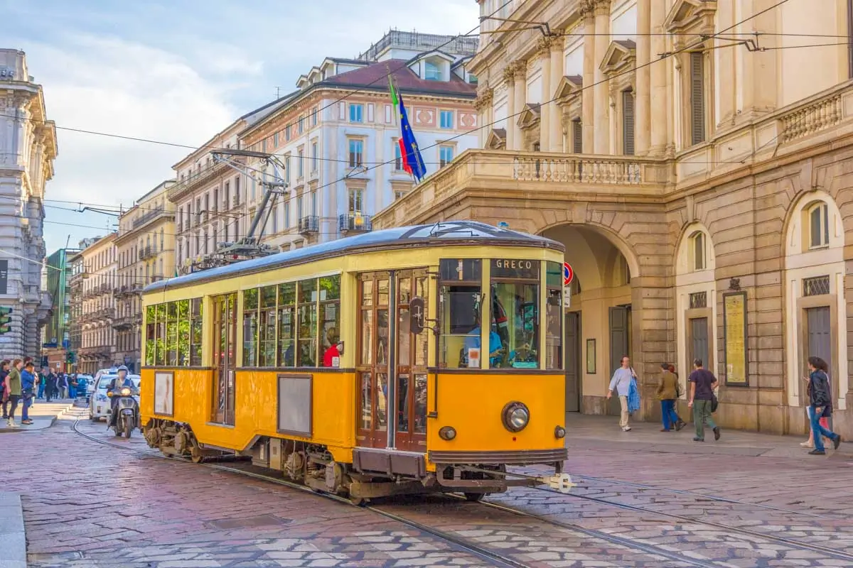 Old tram passing at La Scala theatre in Milan Italy