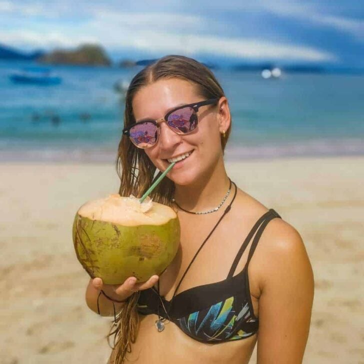 Bailey-sips-a-coconut-in-El Nido Philippines