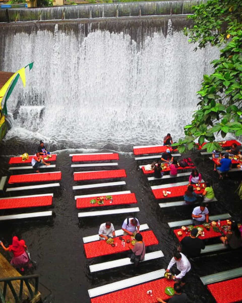 A restaurant at the base of a waterfall seen on a tour of Villa Escudero from Manila