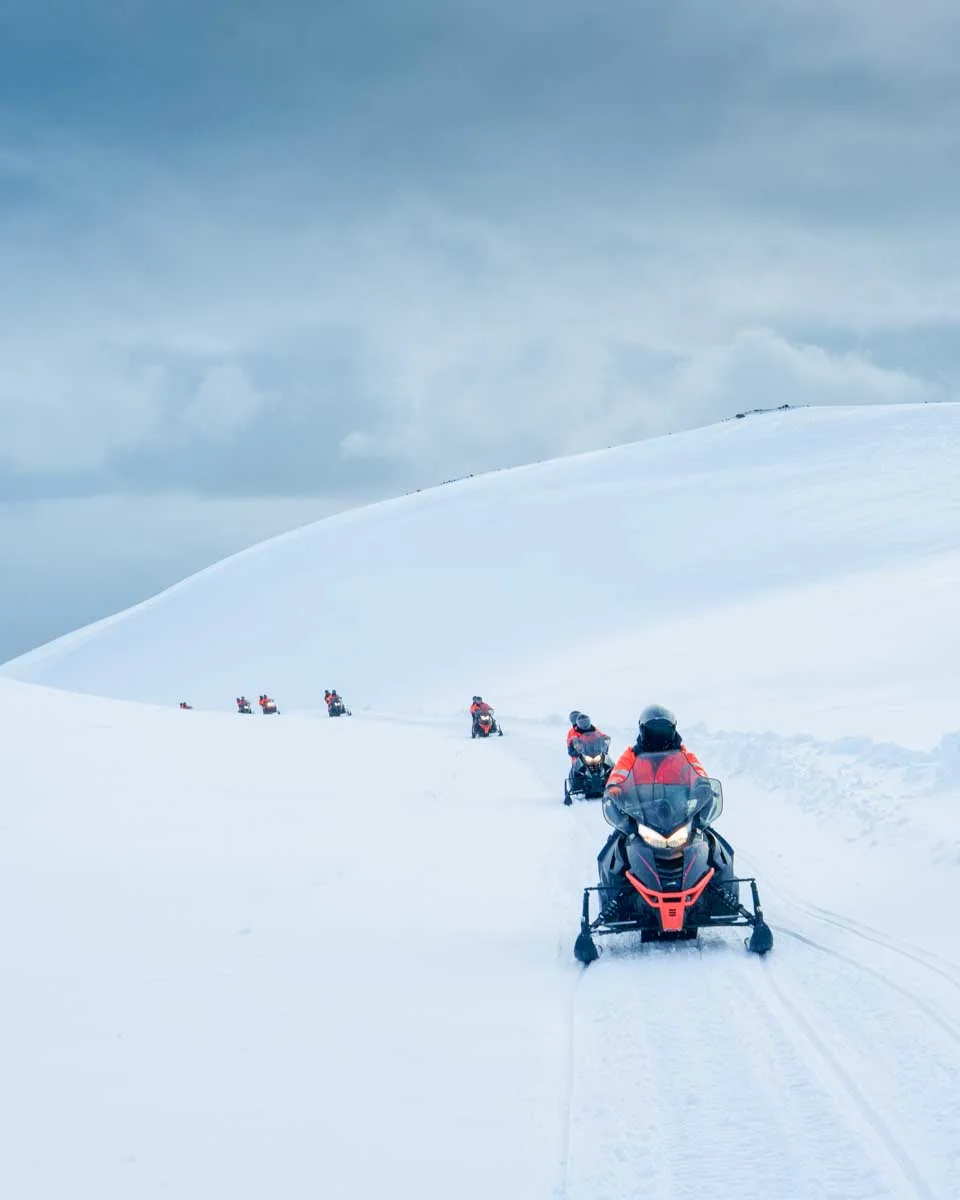 Group of tourist riding snowmobile on a glacier in Iceland