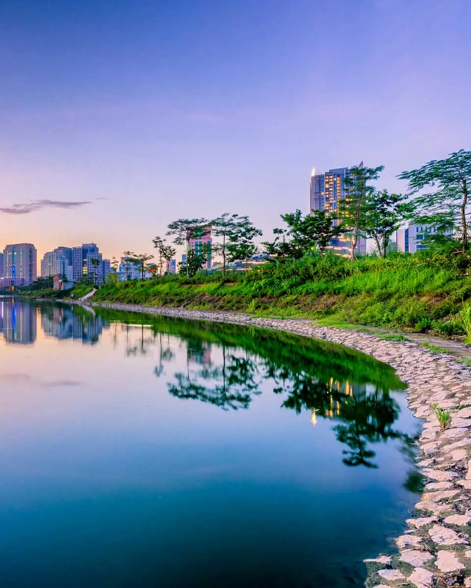 A sunset reflects across Cau Giay Lake Park in Hanoi, Vietnam