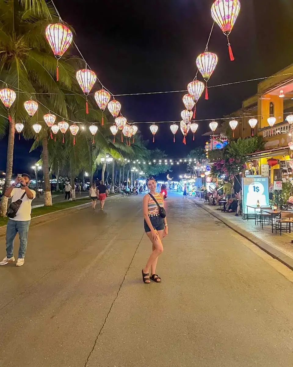 Brittni taking a photo at night market in Hanoi, Vietnam