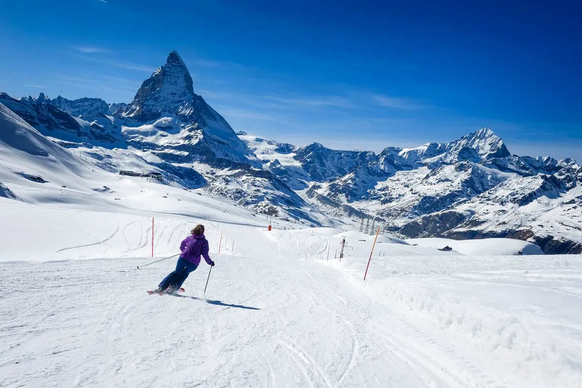 Female skier skiing on the slopes of Matterhorn near Zermatt Switzerland