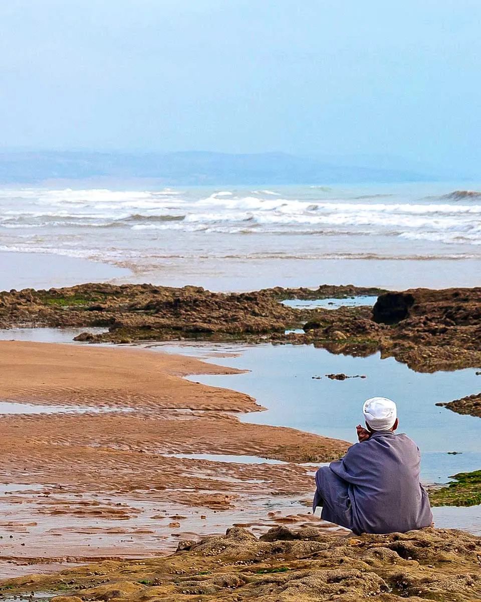 A man on the beach of sidi kaouki on a trip from Essaouira-Morocco