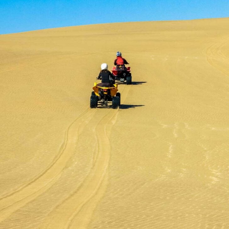 People drive quads in the desert on a tour from Essaouira, Morocco