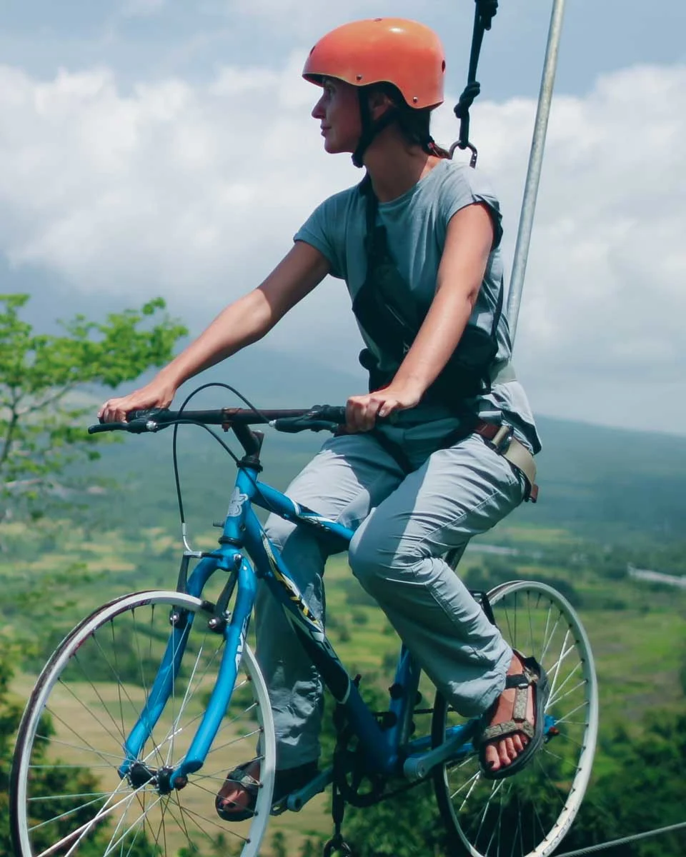 A woman on a bike zipline seen on a tour from San Salvador El Salvador
