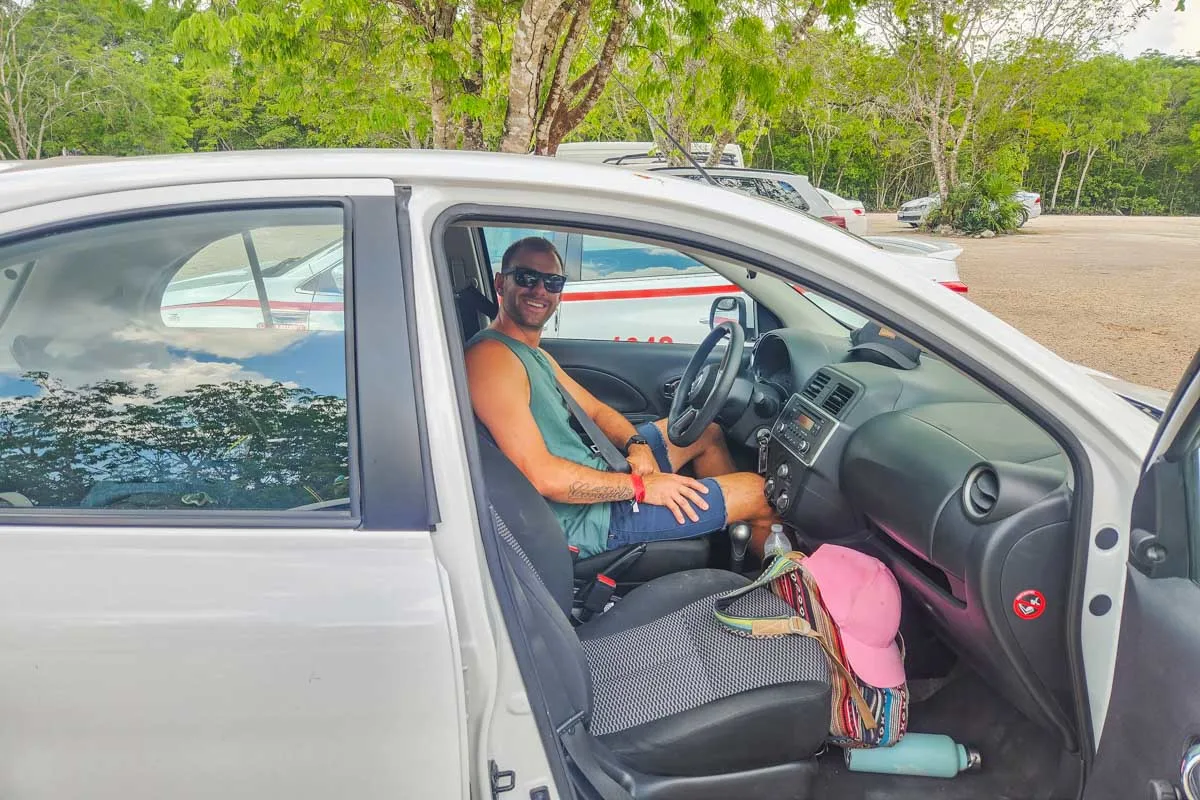 Bailey-takes-a-photo-of-Daniel-while-he-sits-in-our-Belize-Rental-car