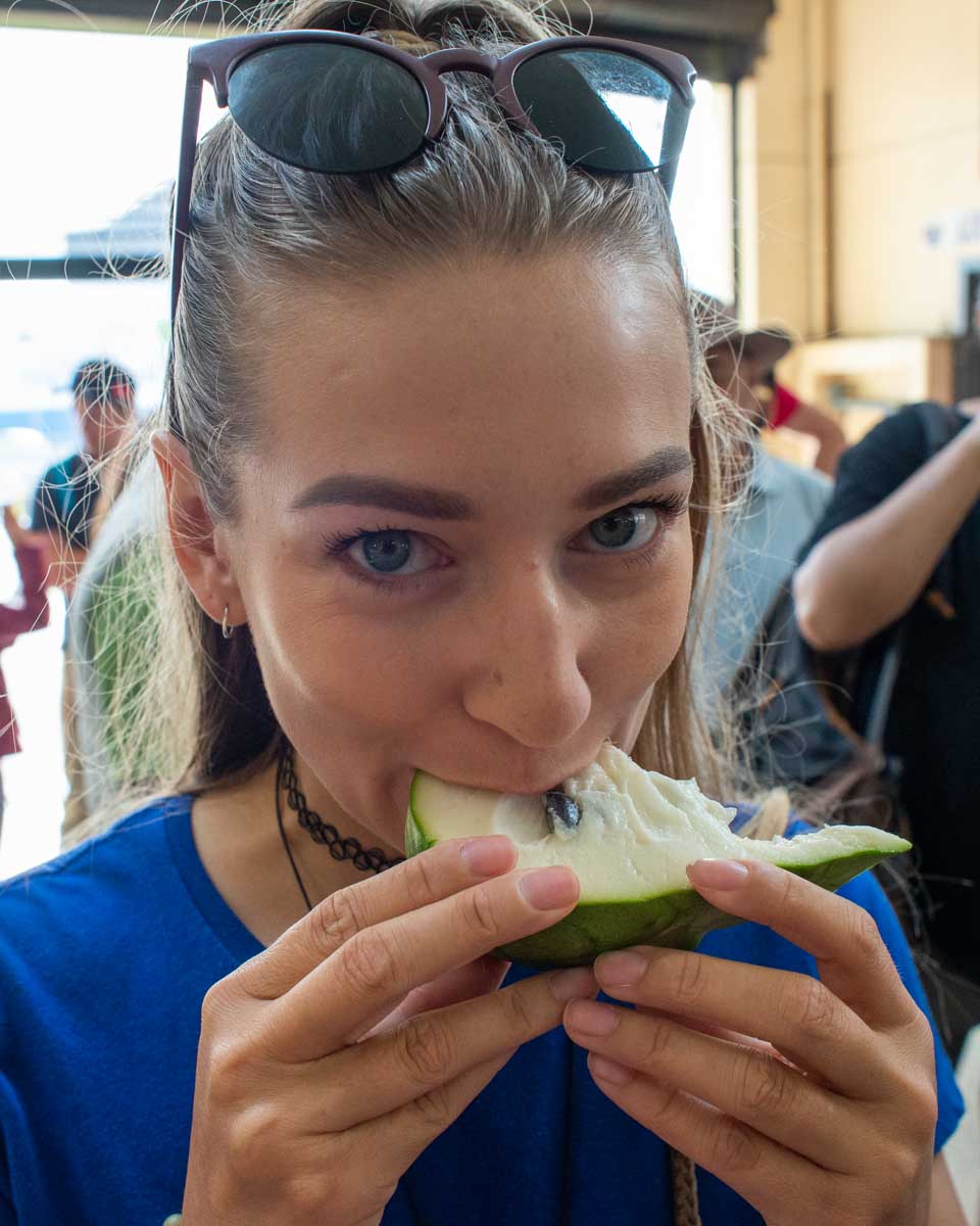 Bailey-bites-into-a-new-fruit-she-tried-on-a-food-tour-in-Santa Marta Colombia
