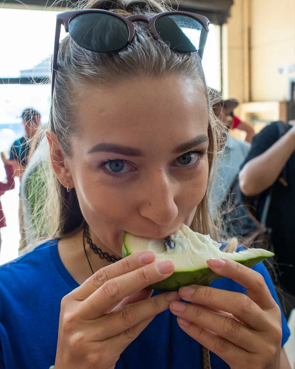 Bailey-bites-into-a-new-fruit-she-tried-on-a-food-tour-in-Santa Marta Colombia