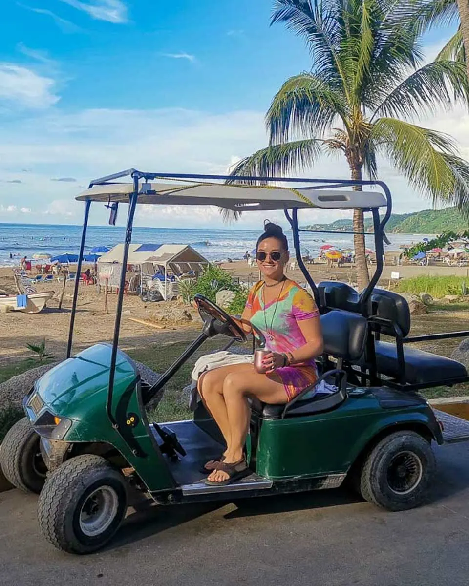 Bailey-drives-a-golf-cart-in-Ambergris Caye Belize