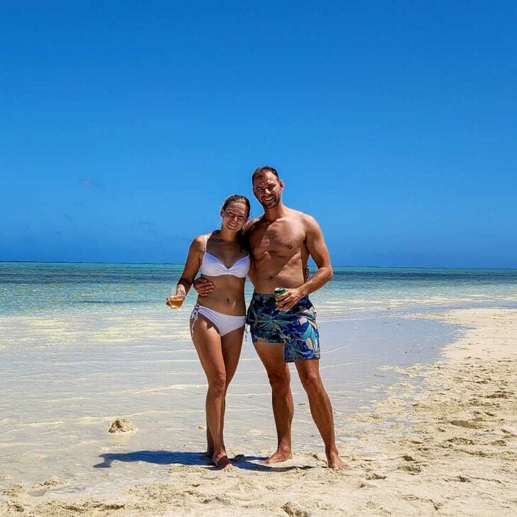 Daniel-and-Bailey-stand-on-a beach in the ocean on a tour from San Andres Colombia