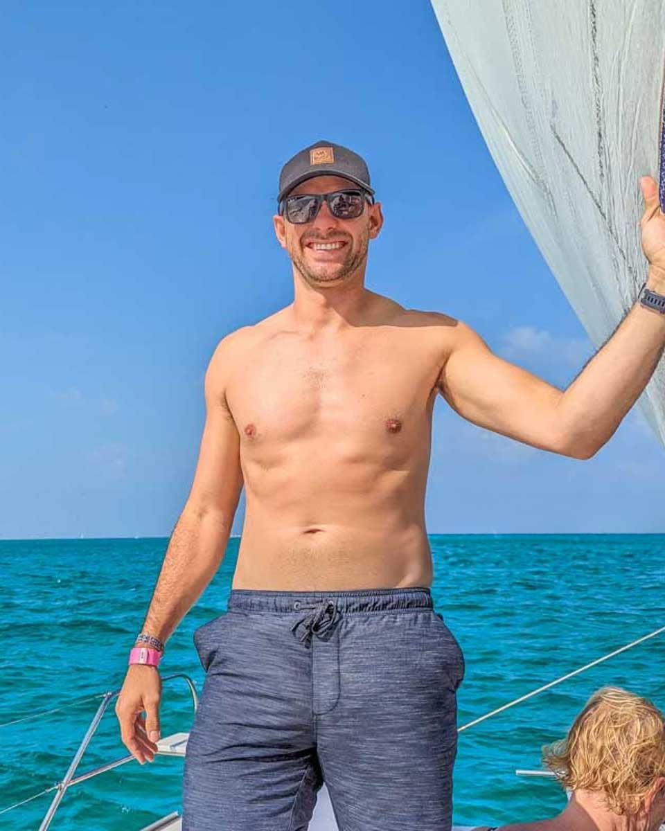 Daniel-poses-for-a-photo-on-a-sailboat-cruise-to Tayrona from Santa Marta Colombia
