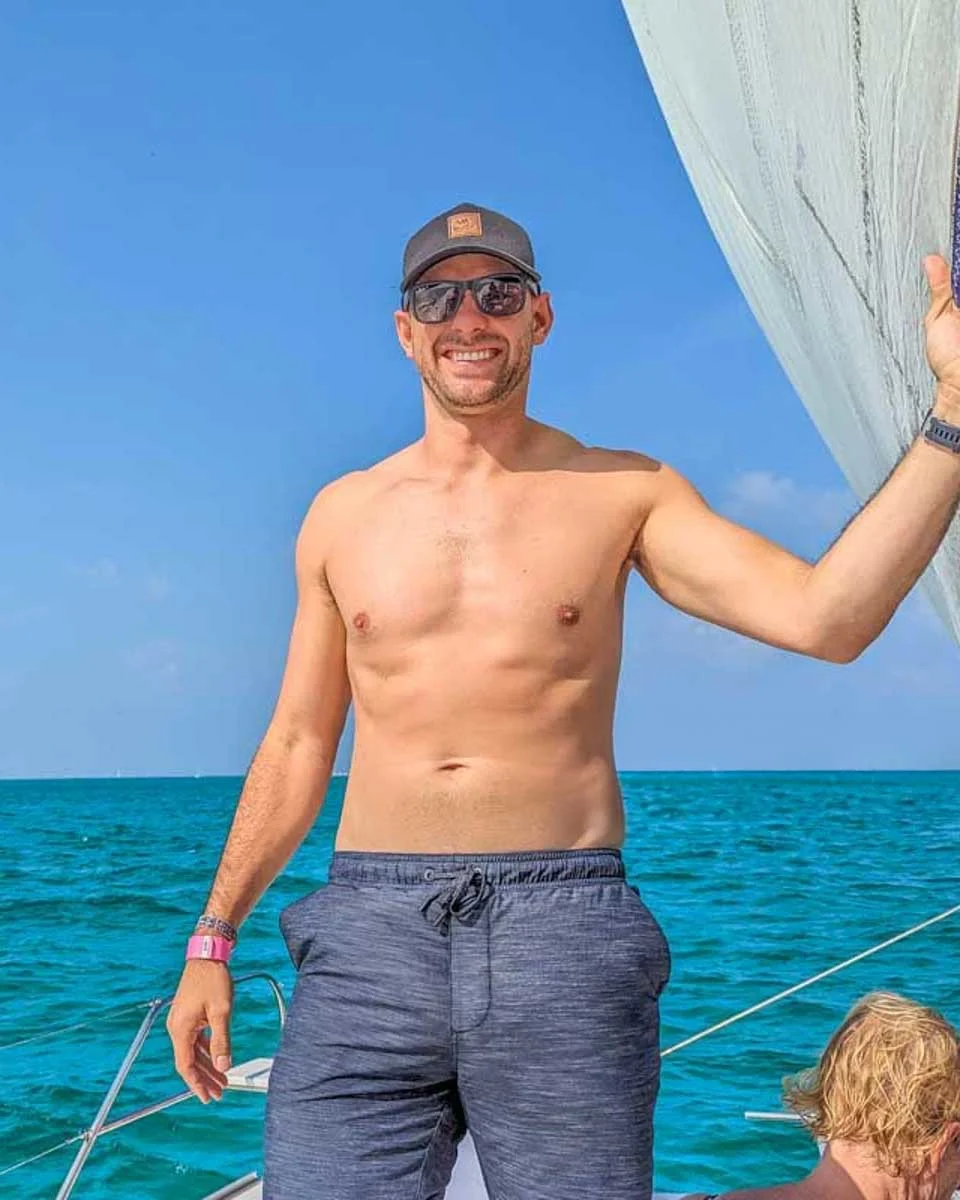 Daniel-poses-for-a-photo-on-a-sailboat-cruise-to Tayrona from Santa Marta Colombia