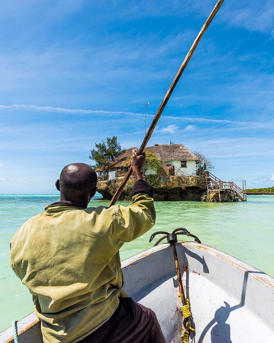 A-man-bringing-a-boat-up-to-the-Rock-Restaurant-in-Zanzibar-Tanzania