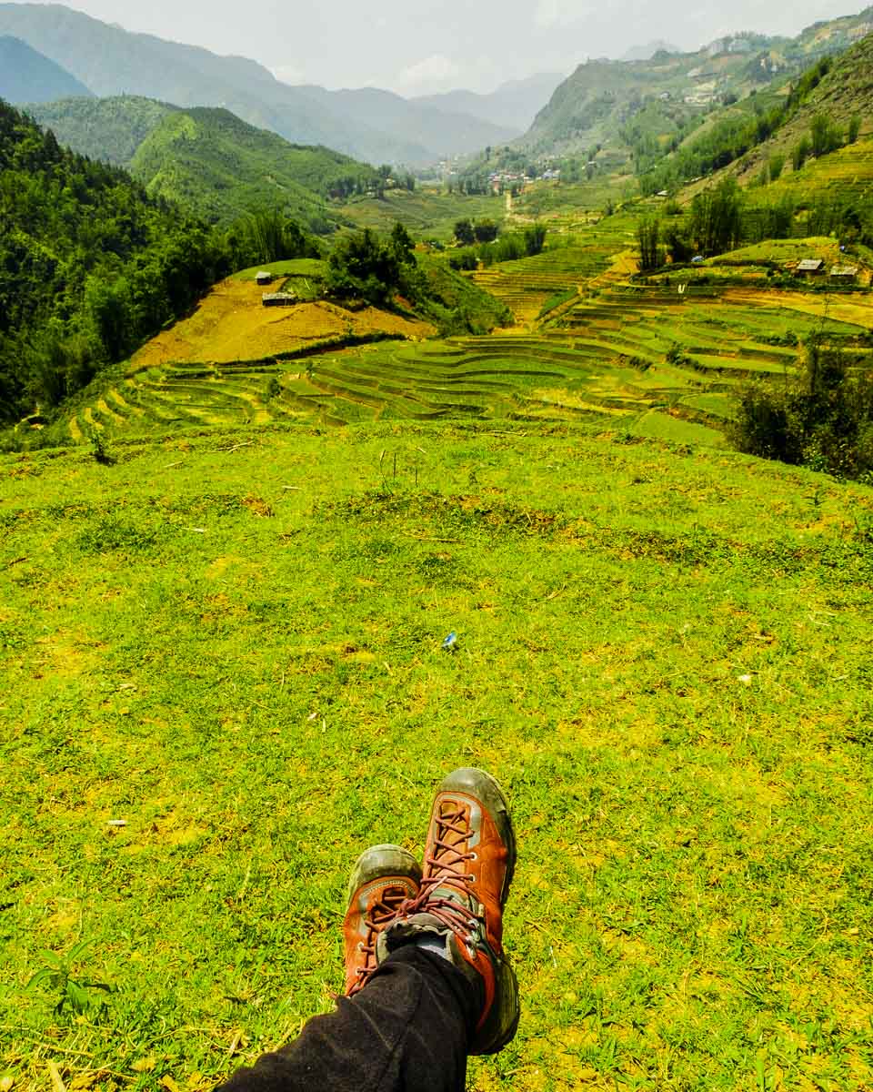 A person sits while on a trek hiking in Sapa Vietnam