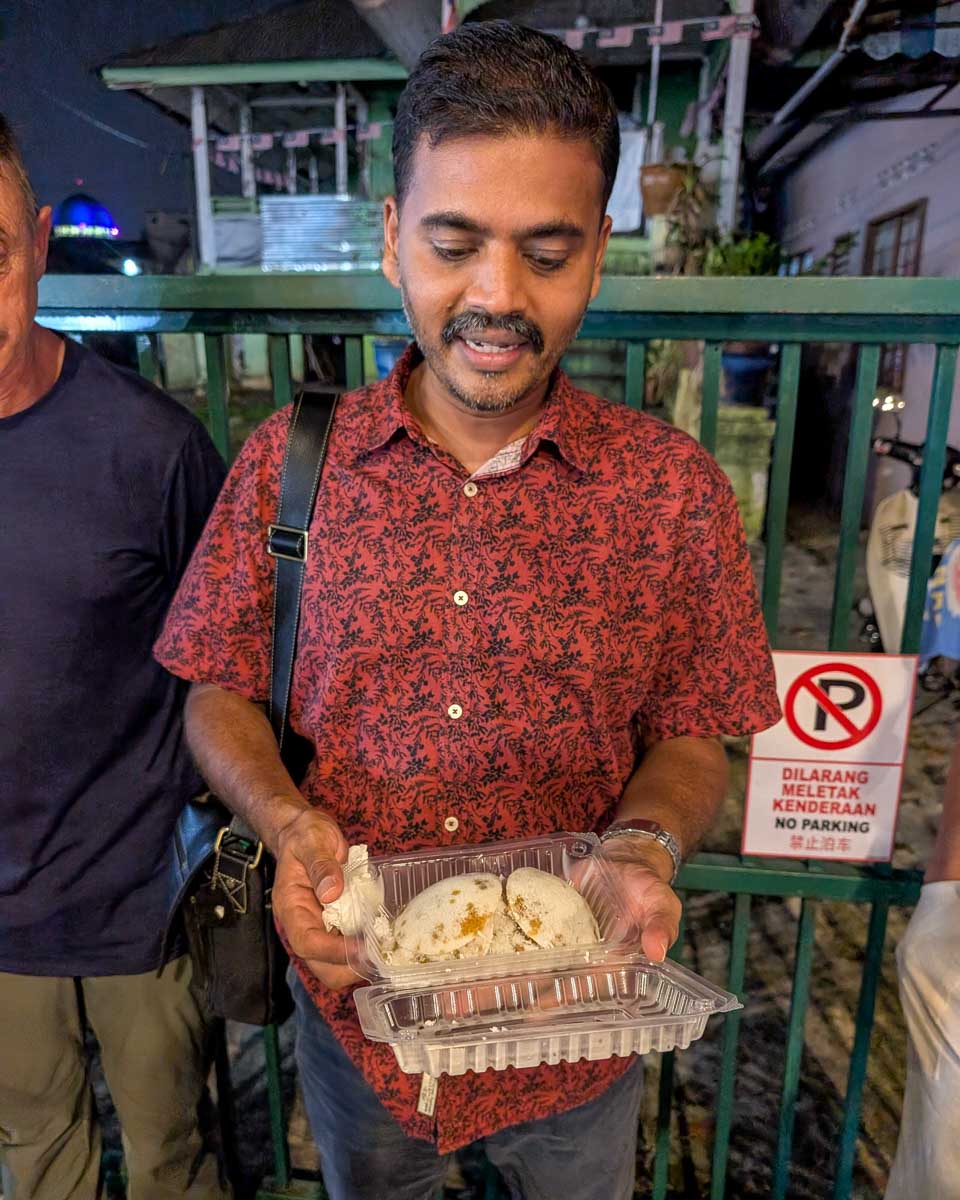 A guide explains food on a food tour in Kuala Lumpur Malaysia