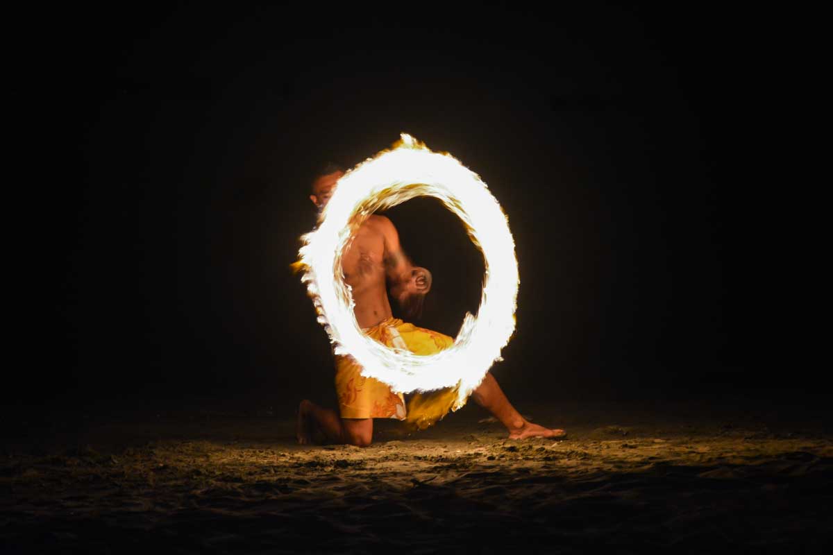 A man in Kona Hawaii at a luau doing a fire dance
