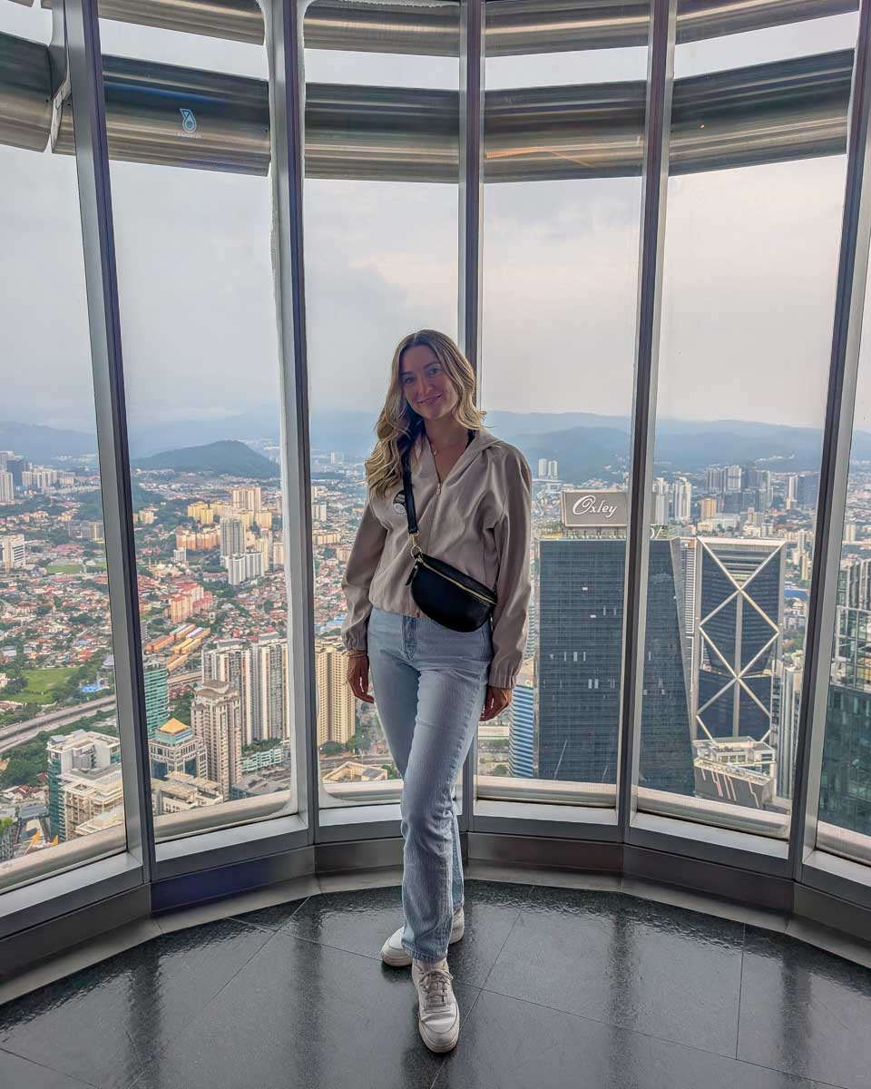 Bailey poses inside the Petronas Tower in Kuala Lumpur Malaysia