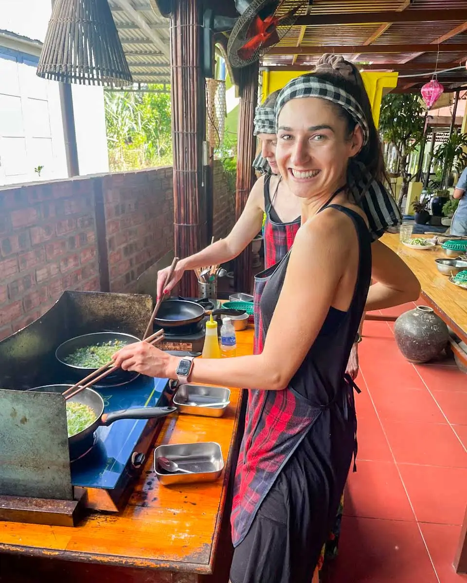 Brittni cooking dishes at a cooking class in Hoi An, Vietnam