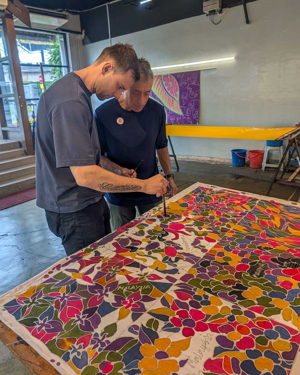 Daniel and his dad at a batik painting workshop for fabrics in Kuala Lumpur Malaysia