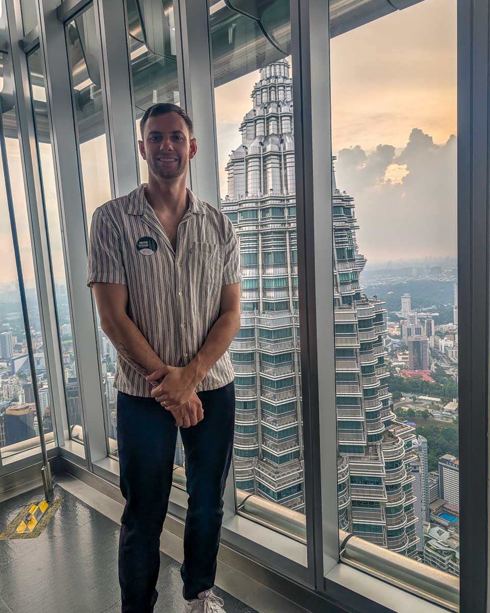 Daniel poses inside the Petronas Towers Kuala Lumpur Malaysia