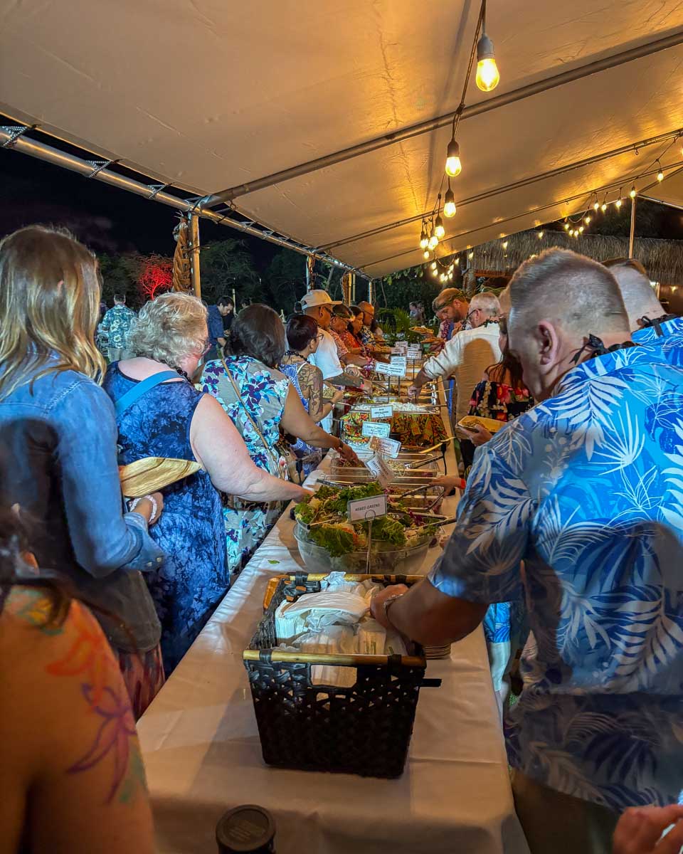 People-grab-food-at-a-buffet-during-a-luau-on-Maui Hawaii