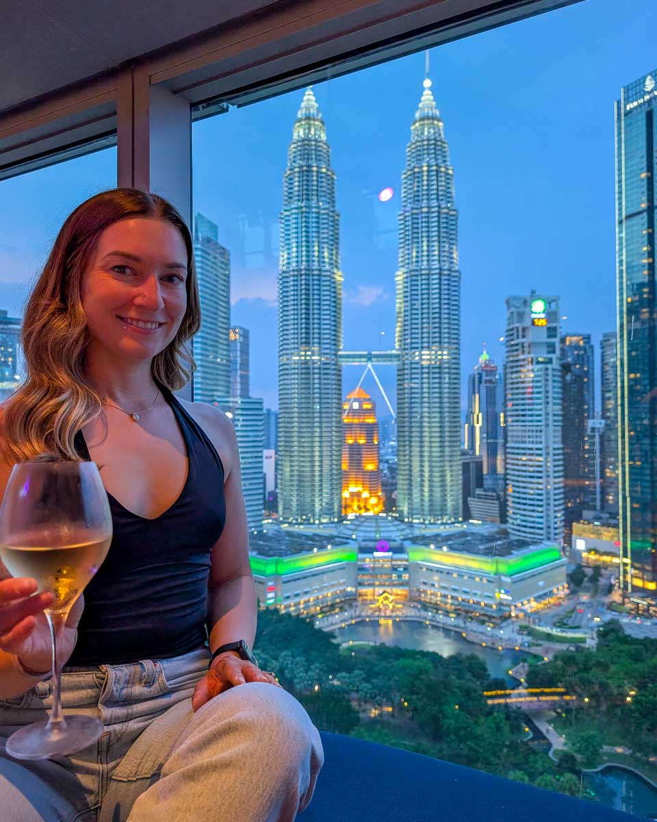 Petronas Towers and Bailey seen holding wine seen from Skybar at Traders Hotel in Kuala Lumpur Malaysia (1)