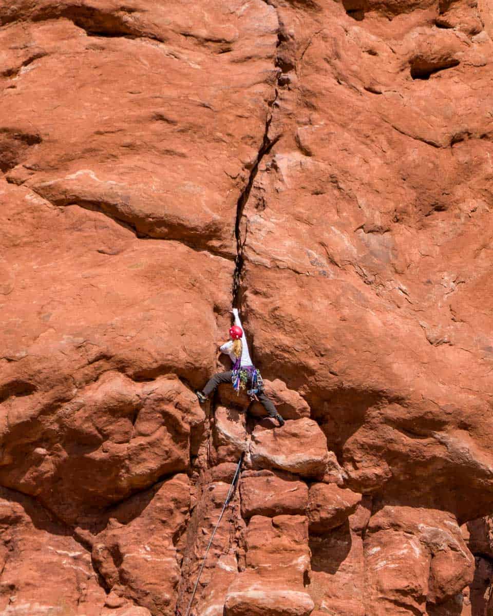 A woman climbs and is canyoneering near Moab Utah