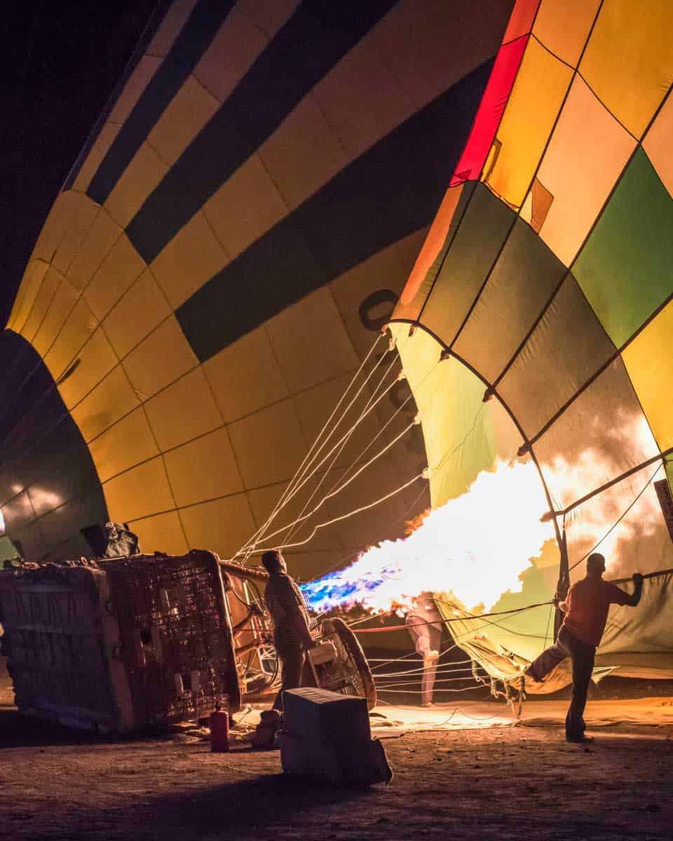 People-blow-up-a-hot-air-balloon-in-the-morning-on-a-tour-from-Cappadocia Turkey