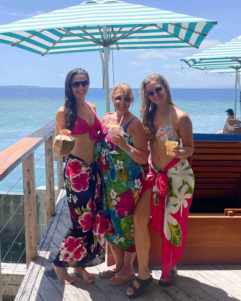 Bailey and her family pose for a photo with their drinks at a beach club