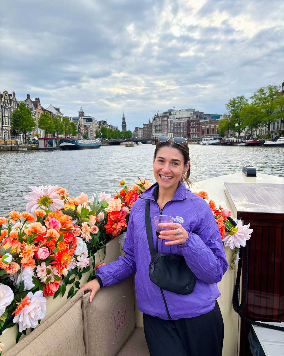 Brittni poses for a photo on a canal boat cruise in Amsterdam