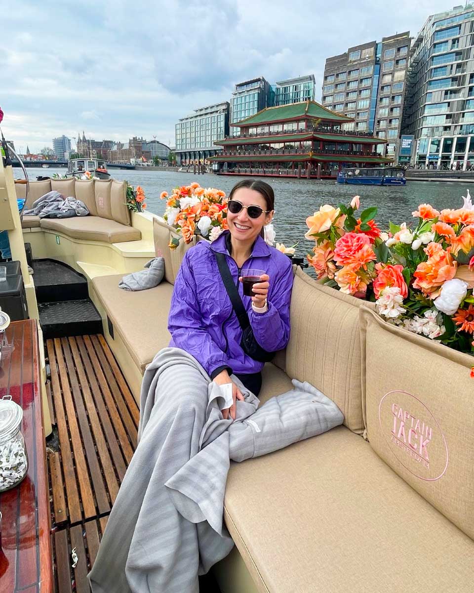 Brittni sips wine on a canal cruise in Amsterdam