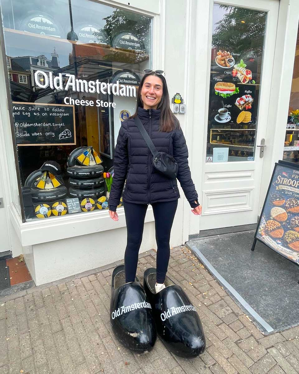 Brittni stands in huge clog shoes in Amsterdam