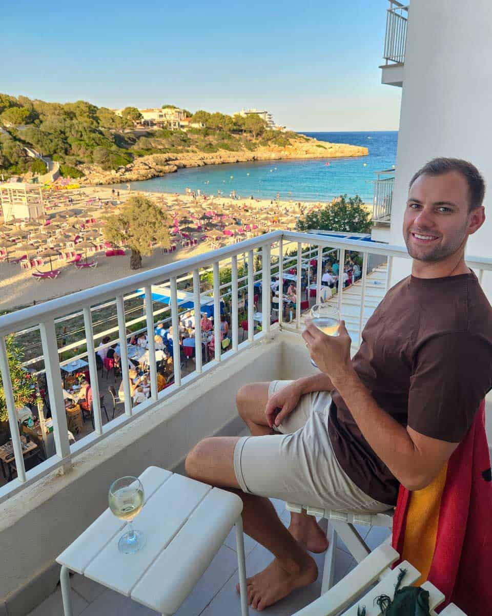 Cala Gran beach in Mallorca Spain from hotel room with Daniel having a beer
