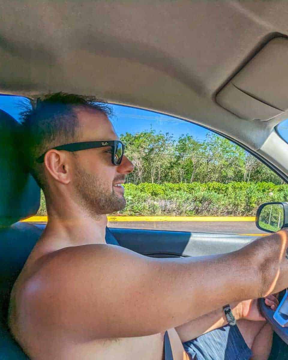 Daniel-drives-along-the-highway-in-a-rental-car-in-Moorea