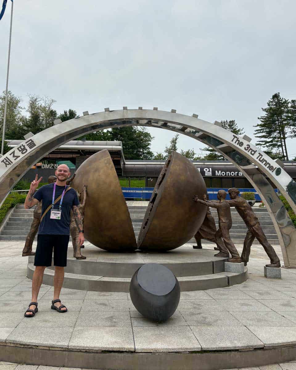 Evan stands at a monument for the reunification of Korea at the 3rd Infiltration Tunnel on a DMZ tour from Seoul South Korea (2)