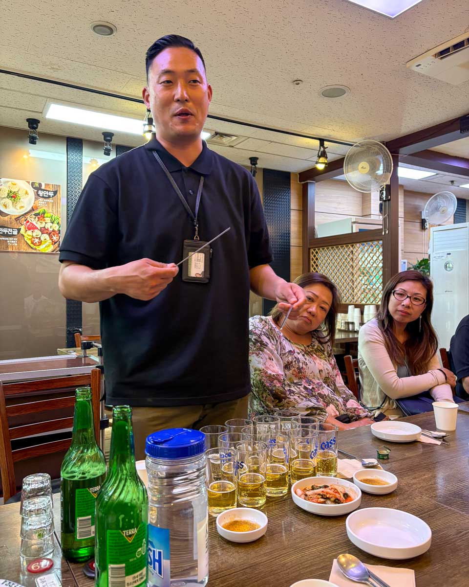 Guide on a food tour teaching us how to mix beer and soju in Seoul South Korea (2)